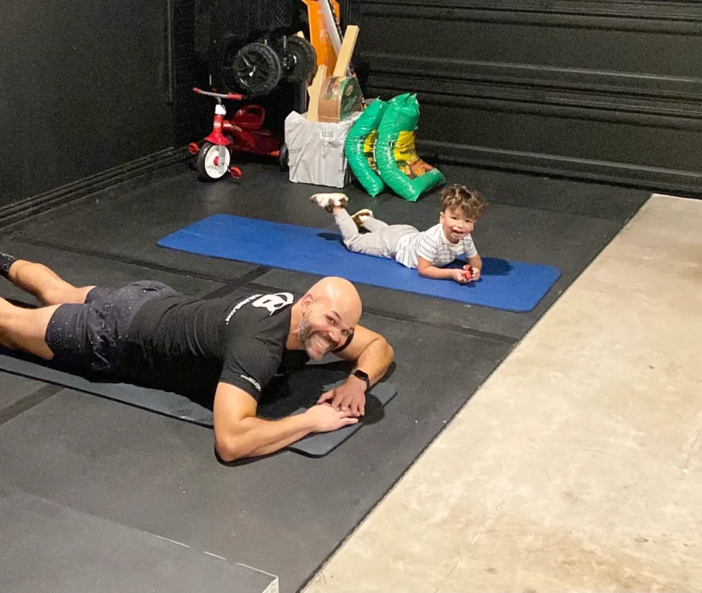 Man and child exercising on yoga mats.
