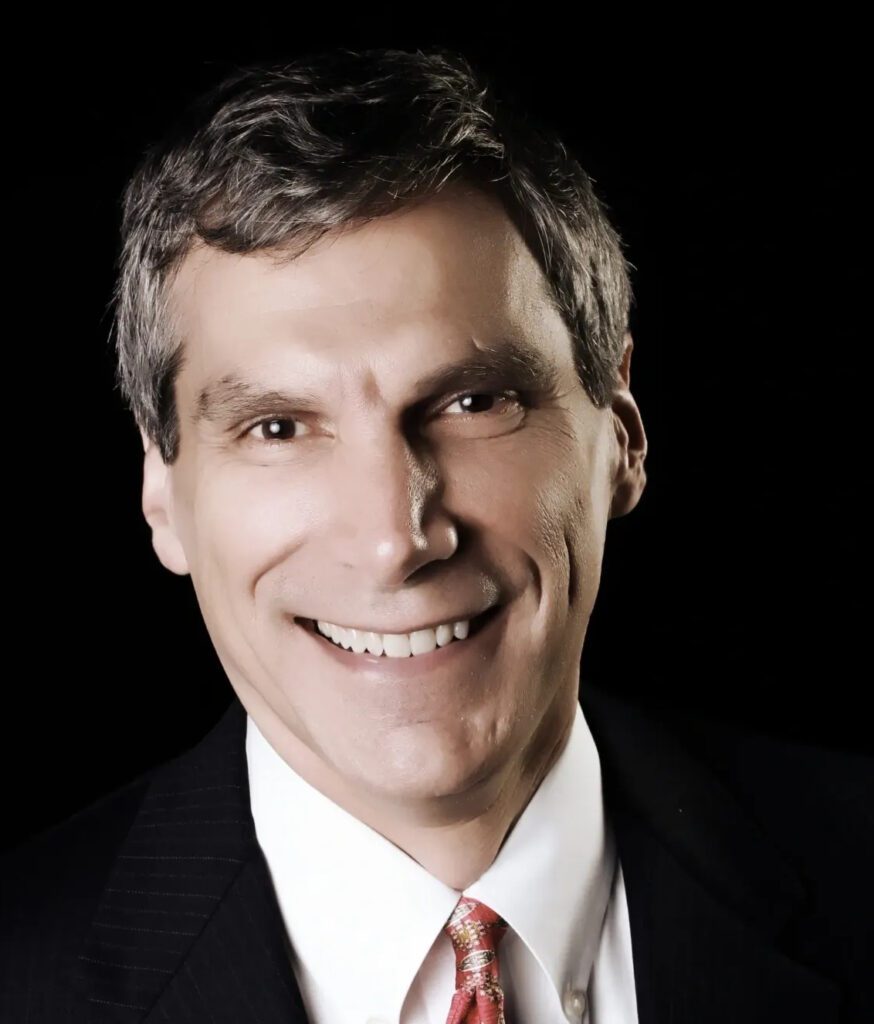 Smiling man in a suit and tie.