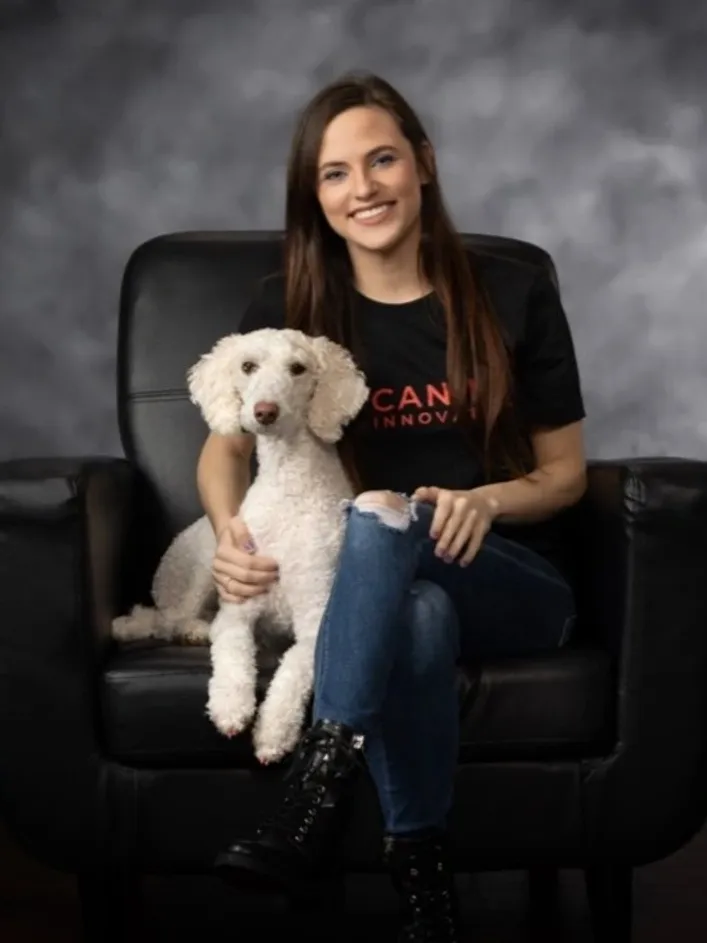 Woman sitting with a white dog.