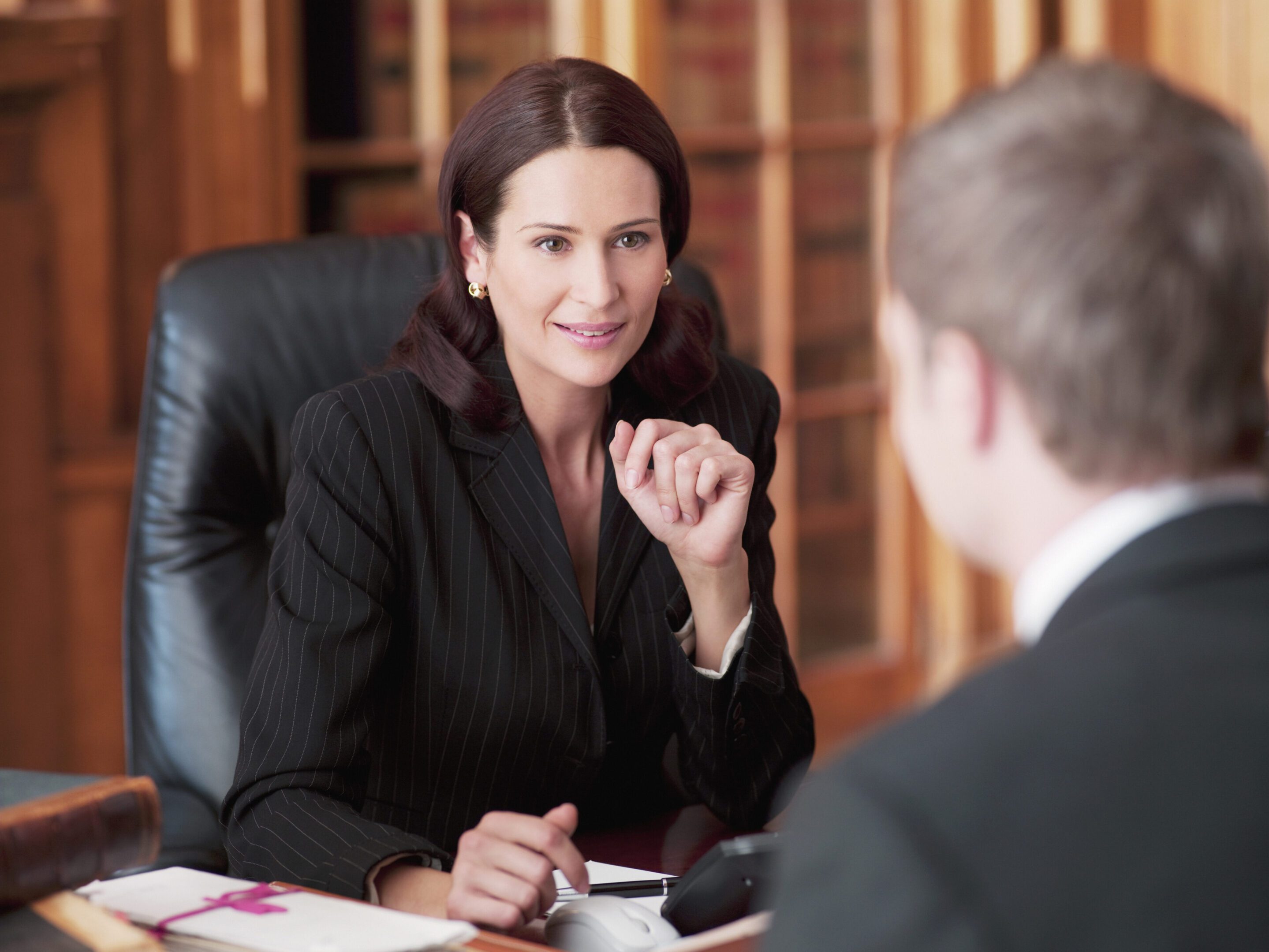 Professional woman discussing business with a colleague.